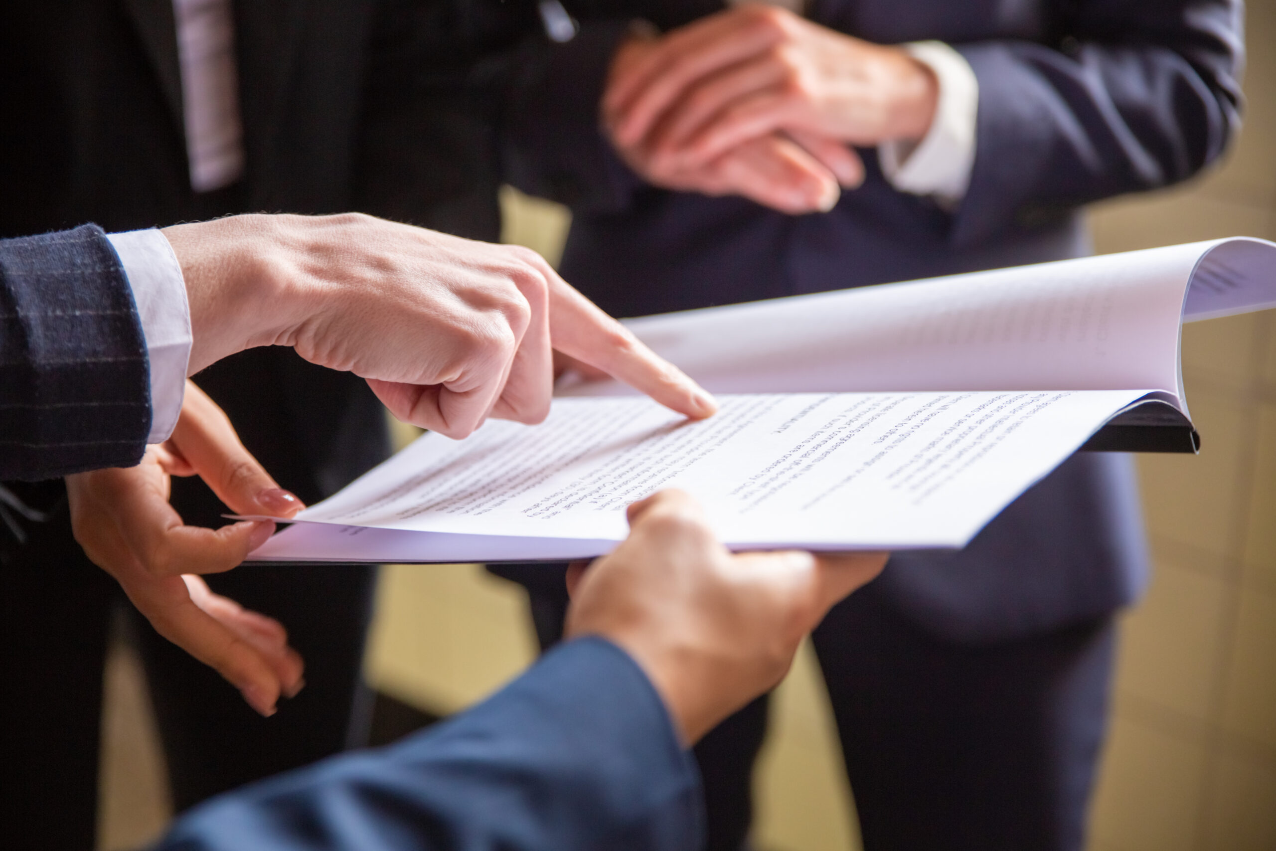Cropped view of businesswomen reading document tax-law