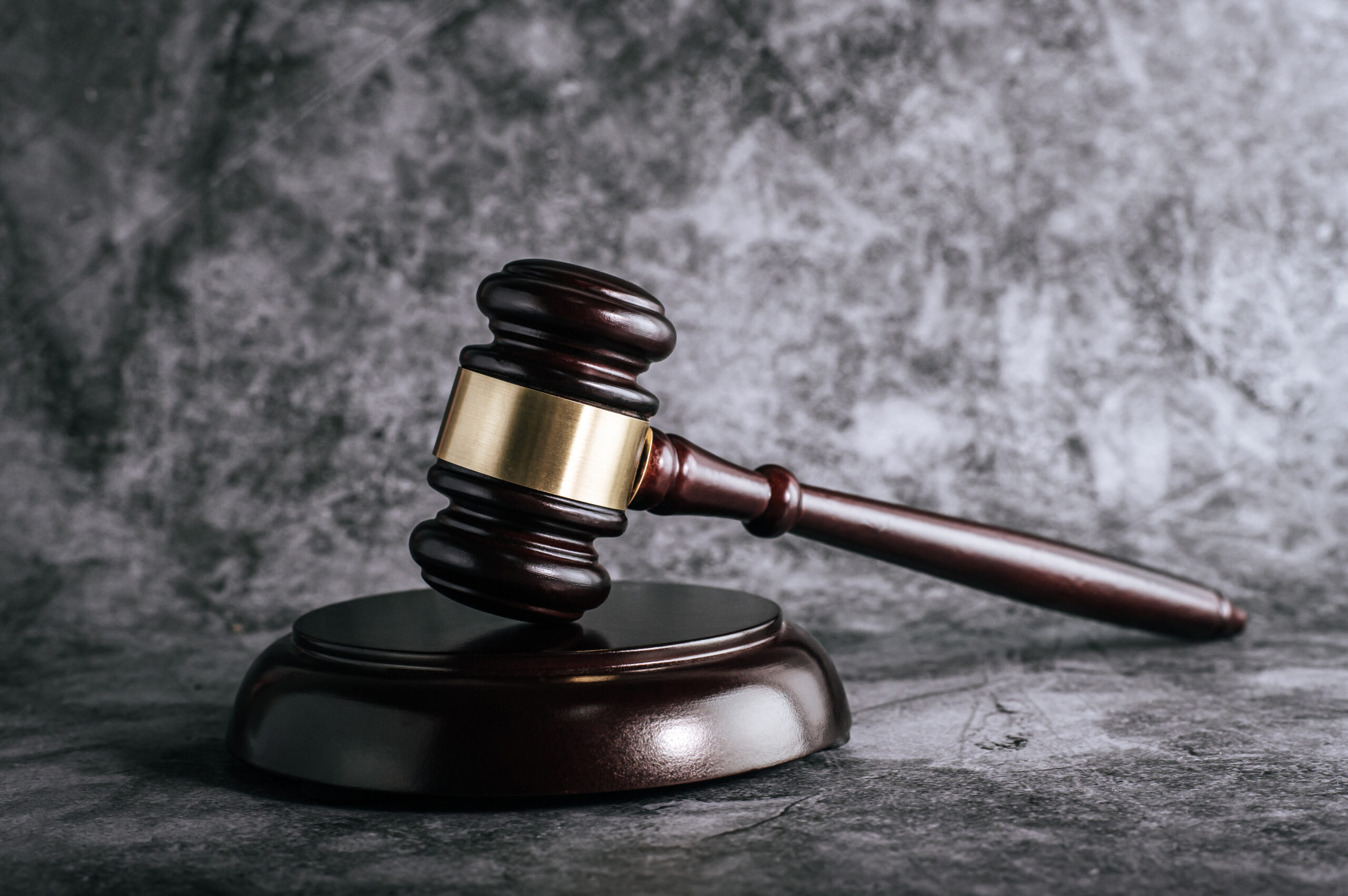 wooden judges gavel on table in a courtroom or enforcement offic tax-law